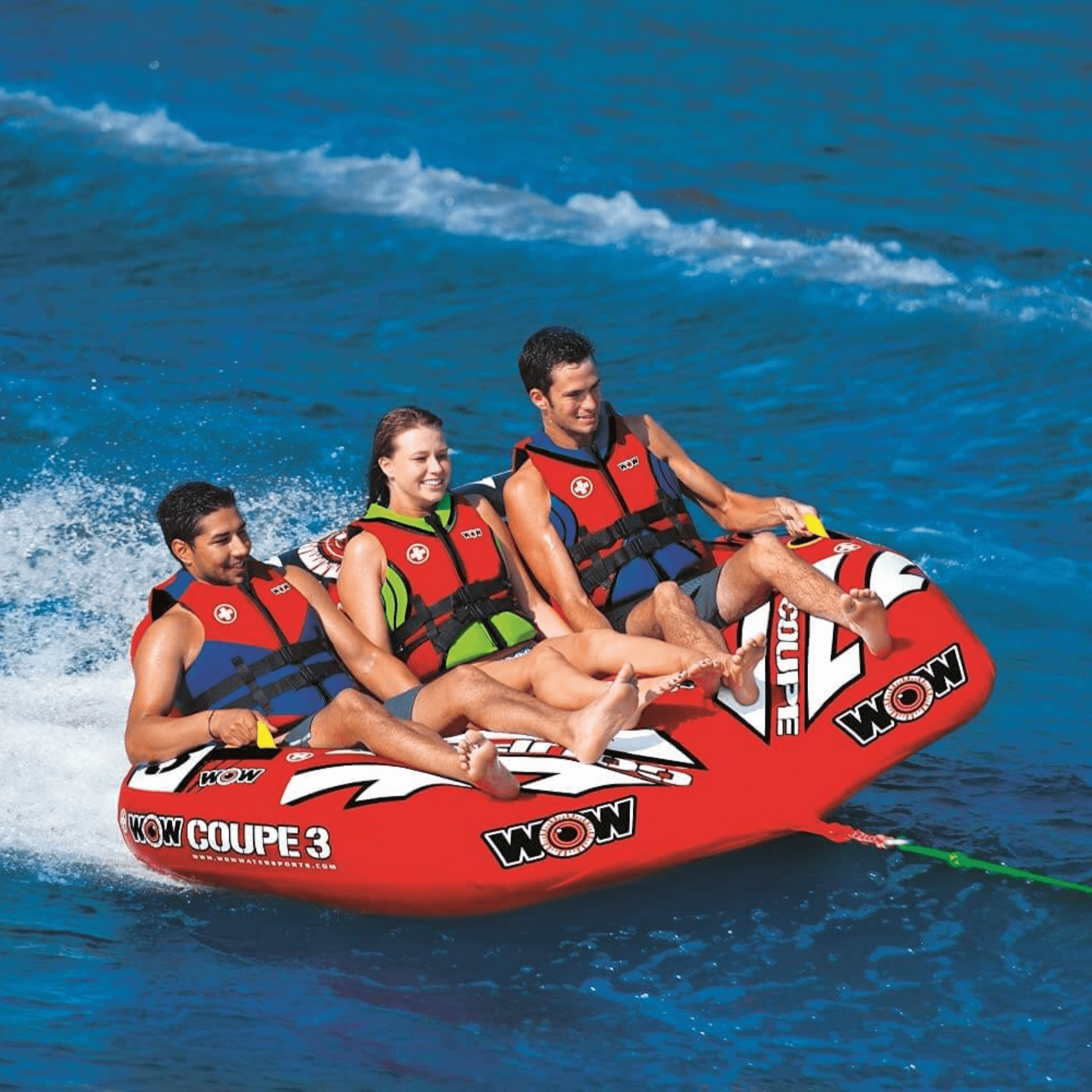 Three people on a red inflatable tube in the water, with 'WOW' branding.