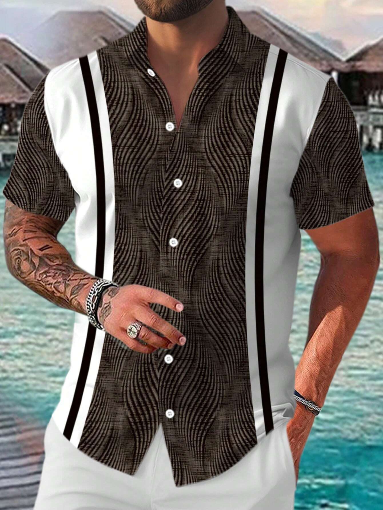 Man wearing a patterned shirt with suspenders by a waterfront