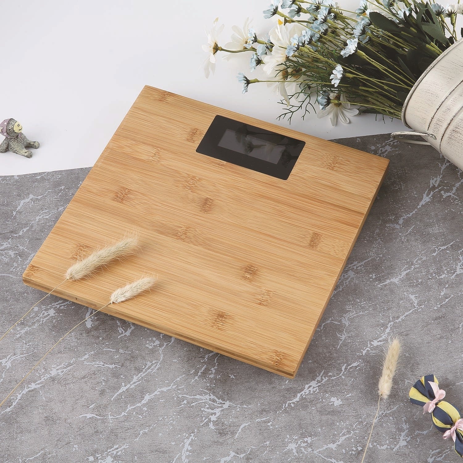 Wooden digital scale on a marble surface with decorative elements.
