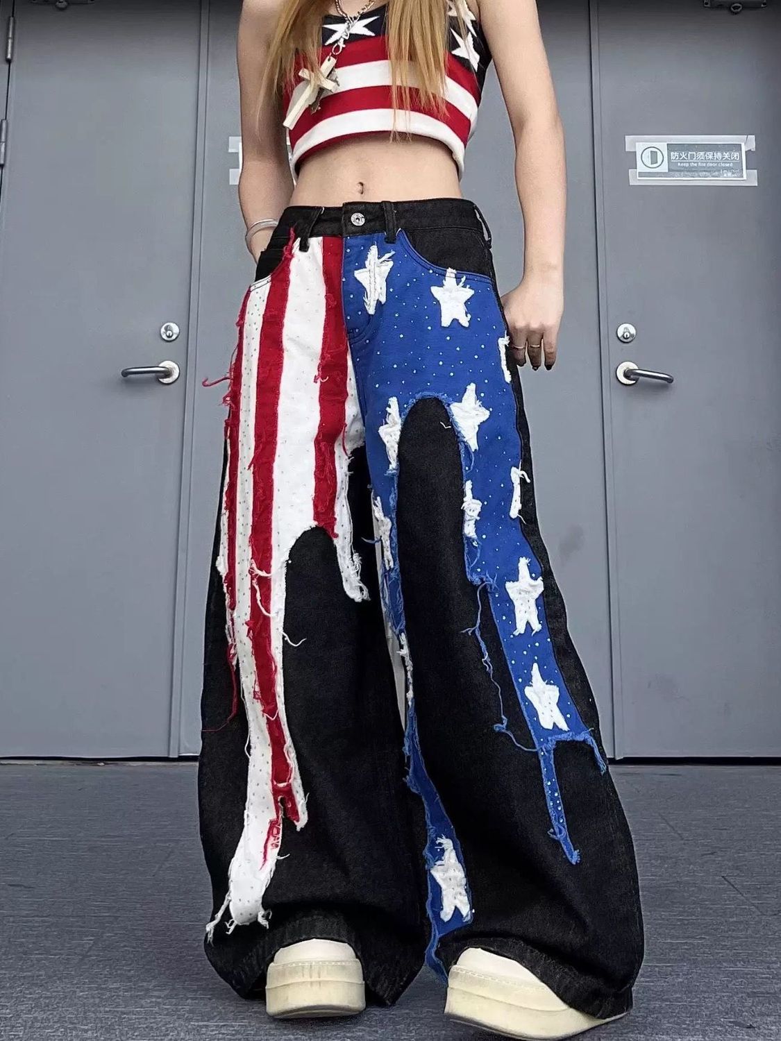 Person wearing a outfit with American flag design in front of a gray door.