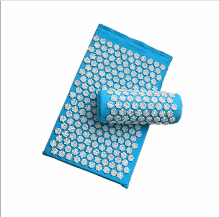 Blue acupressure mat with rolled-up version on a white background