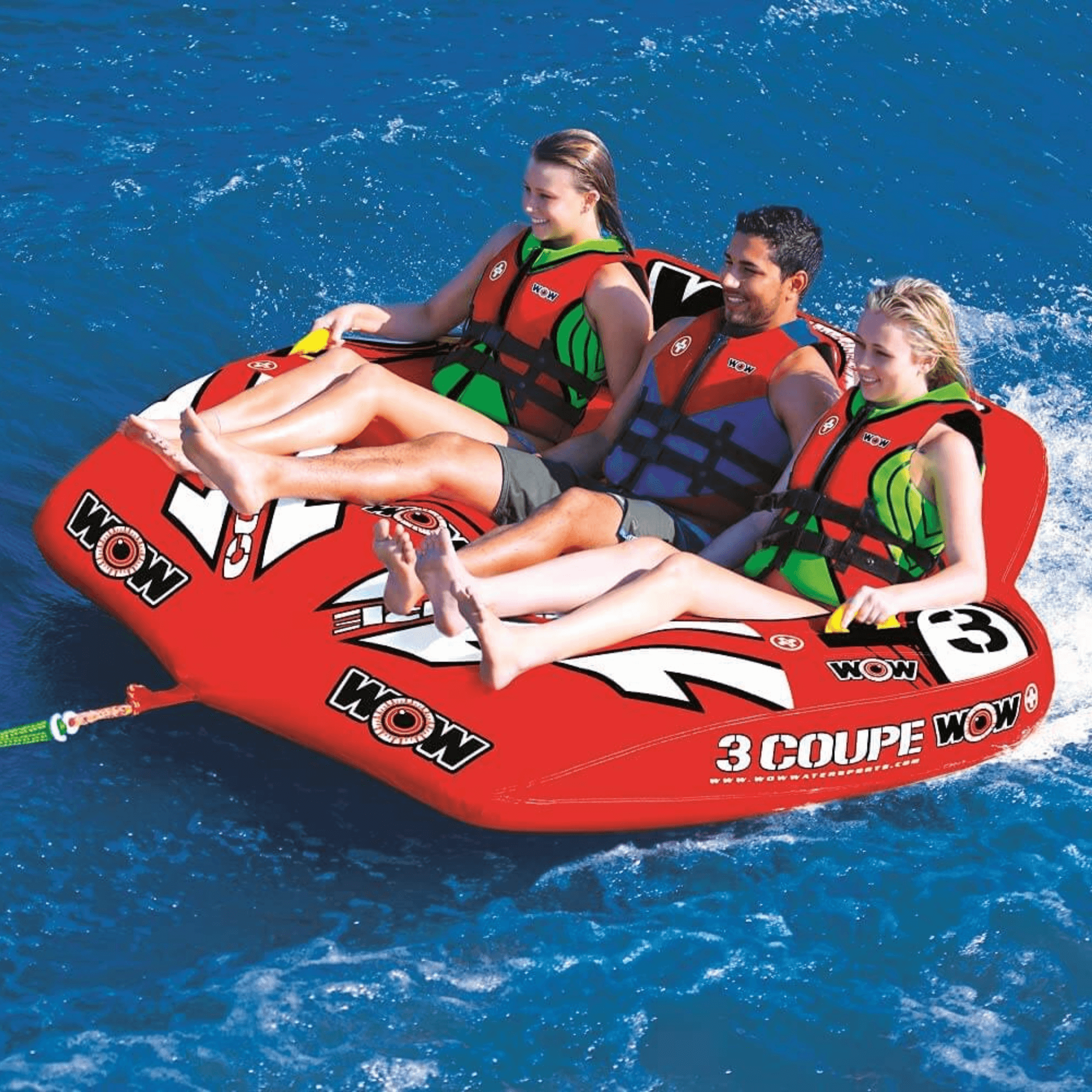 Three people on a red inflatable tube in the water, with 'WOW' branding.