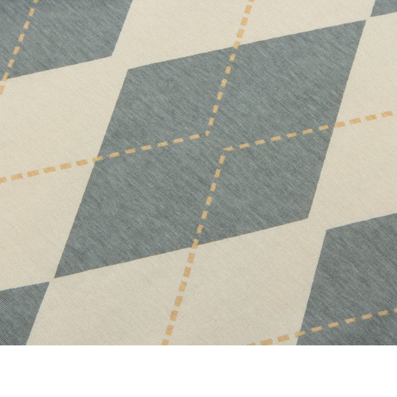 Close-up of a geometric patterned fabric with blue and beige colors.