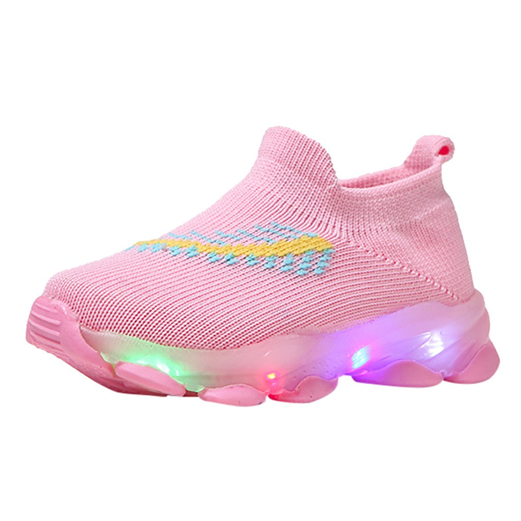 Pink children's shoe with LED lights on a white background