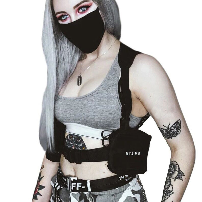 Person wearing a black harness with visible branding on a white background