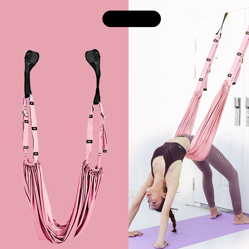 Pink aerial yoga hammock with black attachments on a pink background, and a person using it in a studio.