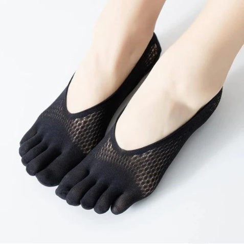 Black five-finger socks worn by a person on a light gray background