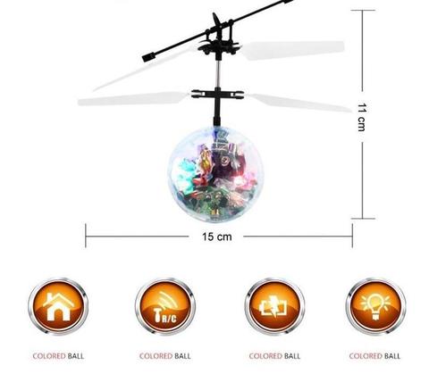 Helicopter toy with colored ball inside, showing dimensions and control buttons on a white background.