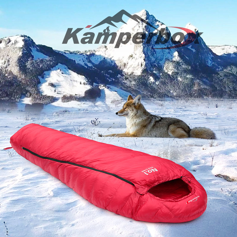 Red sleeping bag on snow with a wolf and mountain landscape, featuring the Kamperbox logo.