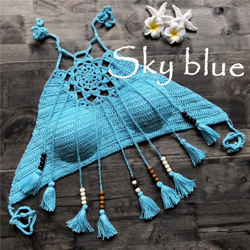 Crocheted blue top with tassels on a wooden surface, labeled 'Sky blue'.