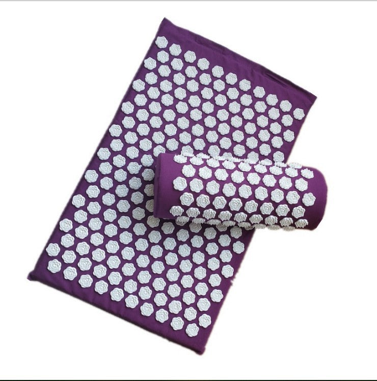 Purple acupressure mat with white hexagonal patterns and a matching roller on a white background