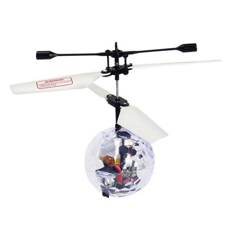 Toy helicopter with transparent sphere and remote control on a white background