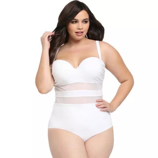 Woman wearing a white swimsuit with sheer mesh panels on a white background