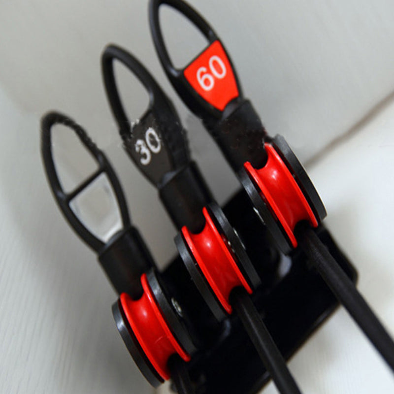 Set of three fishing rods with red guides and black handles on a white background