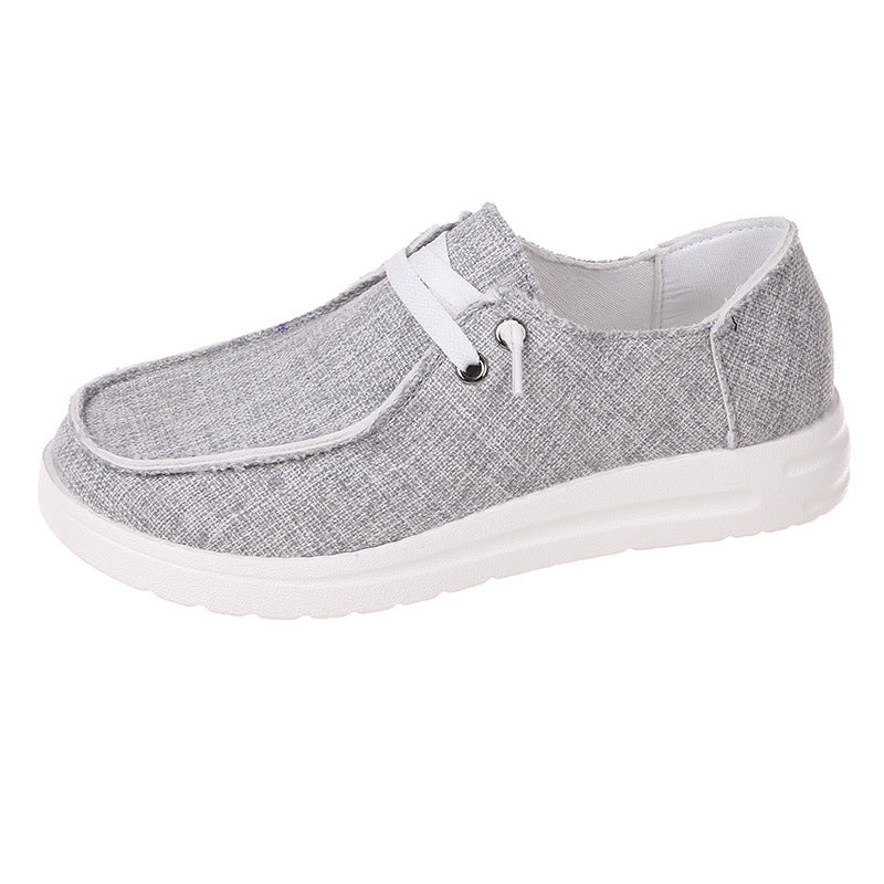 Gray casual shoe with white laces on a white background