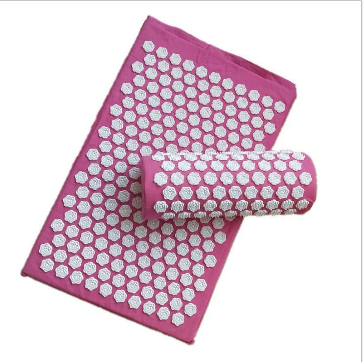 Pink acupressure mat with white hexagonal patterns on a white background