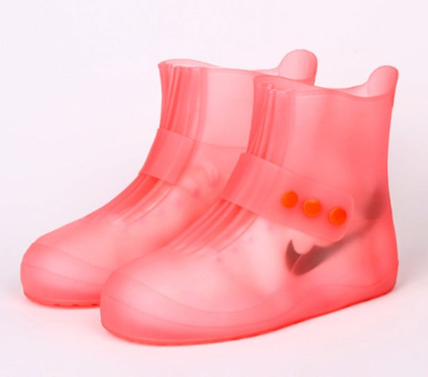 Pair of pink rain boots on a white background