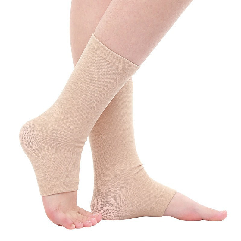 Beige ankle compression sleeves worn on both legs, shown on a clean white background.