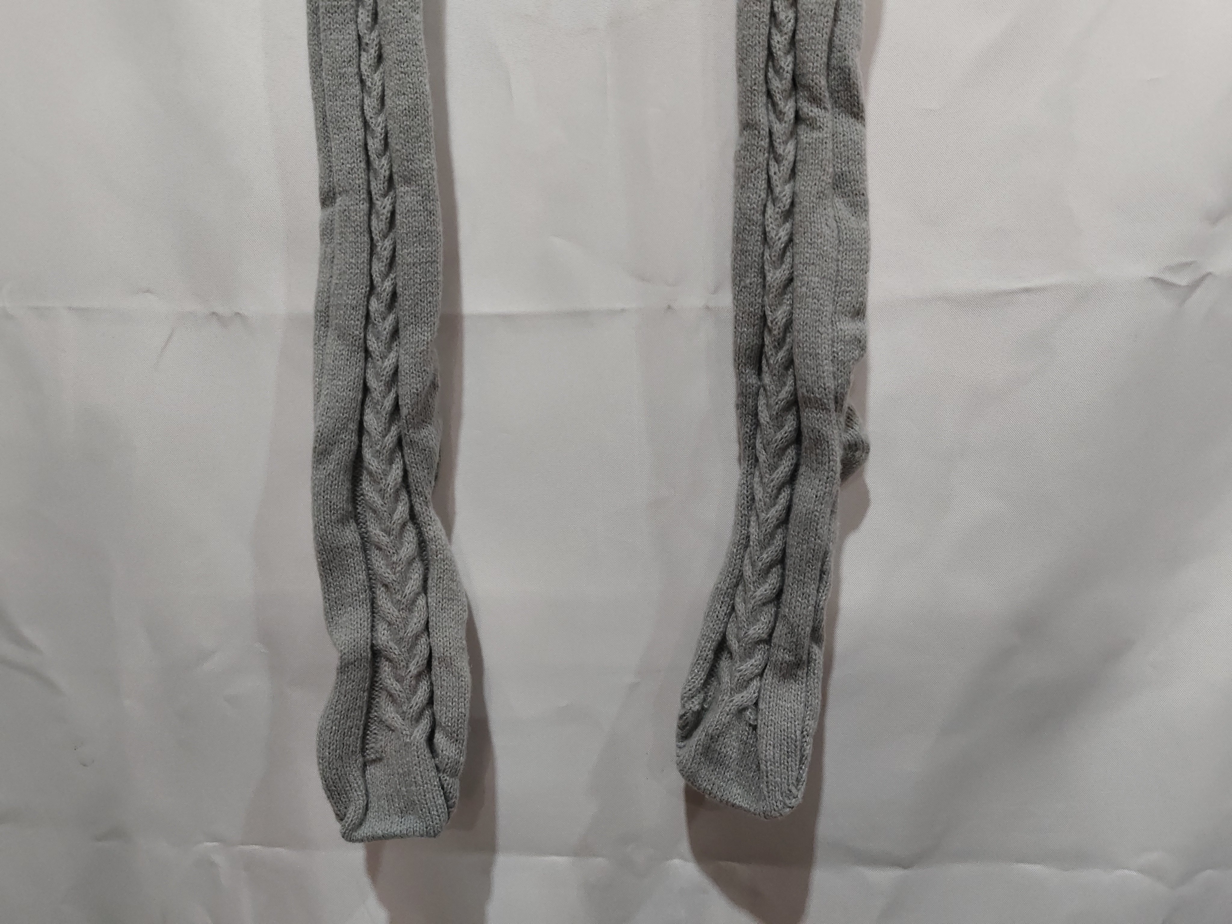 Two braided gray straps on a light gray background