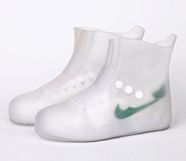 Pair of transparent rain boots on a white background