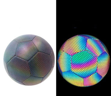 Two soccer balls, one metallic gray and one iridescent multicolor, on a white and black background.