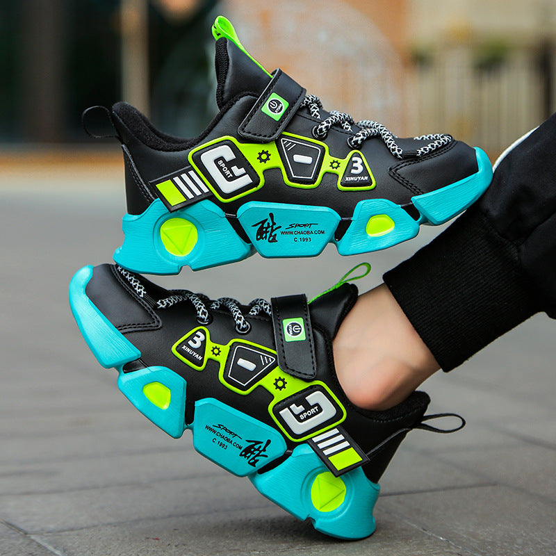 Black and turquoise sneakers with green accents worn by a person on a blurred street background
