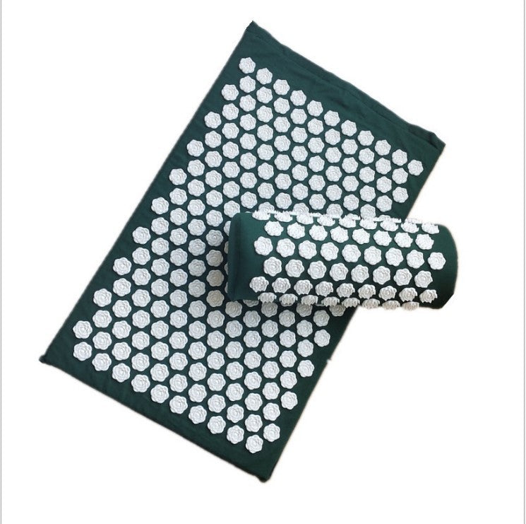 Acupressure mat with rolled-up massage roller on a white background