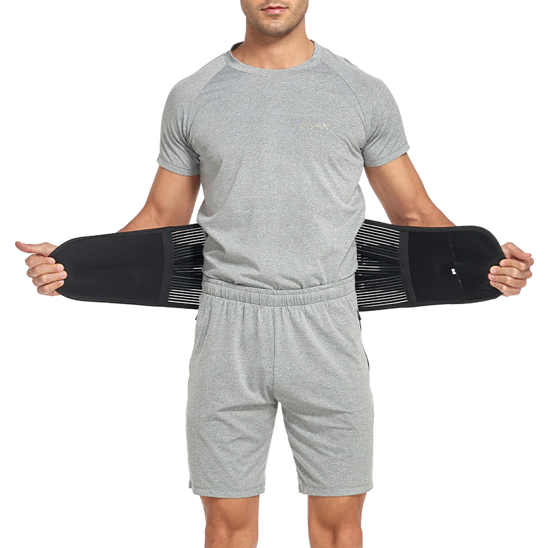 Person wearing a black waist support belt on a white background
