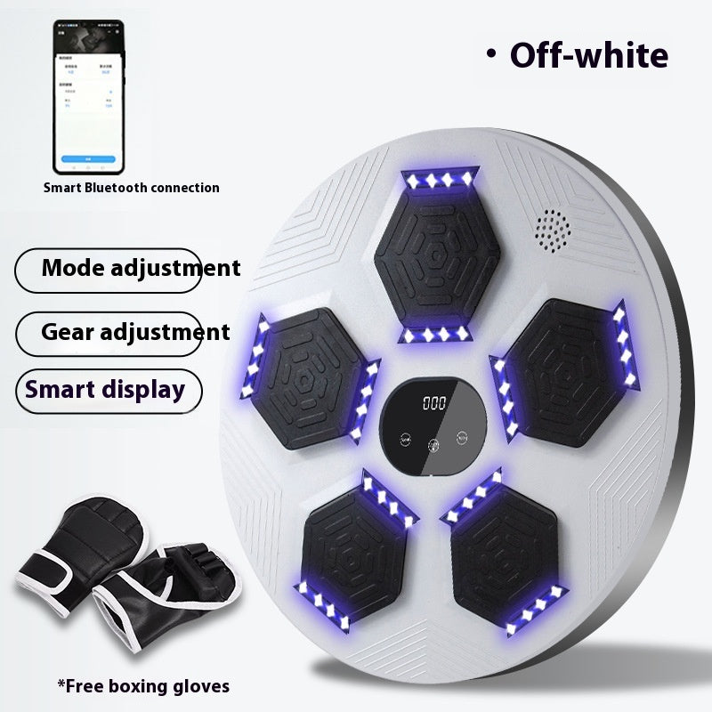White exercise ball with black hexagonal nodes and blue lights, accompanied by black gloves on a white background.
