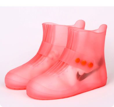 Pink rain boots with a white background