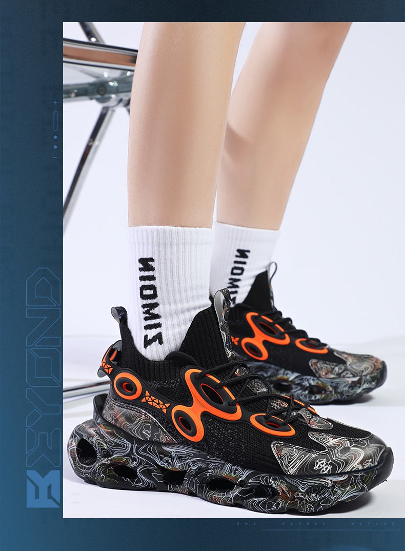Black and orange sneakers with white socks on a light background
