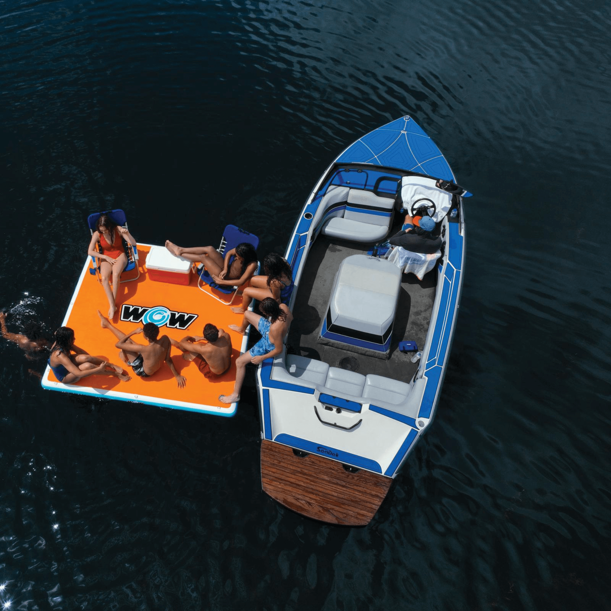Boat and inflatable platform with people on a body of water