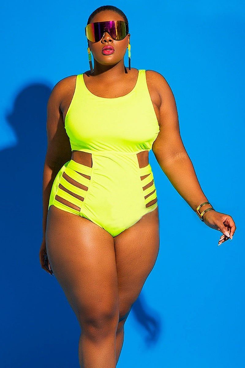 Woman wearing a bright yellow swimsuit with cut-out design against a blue background