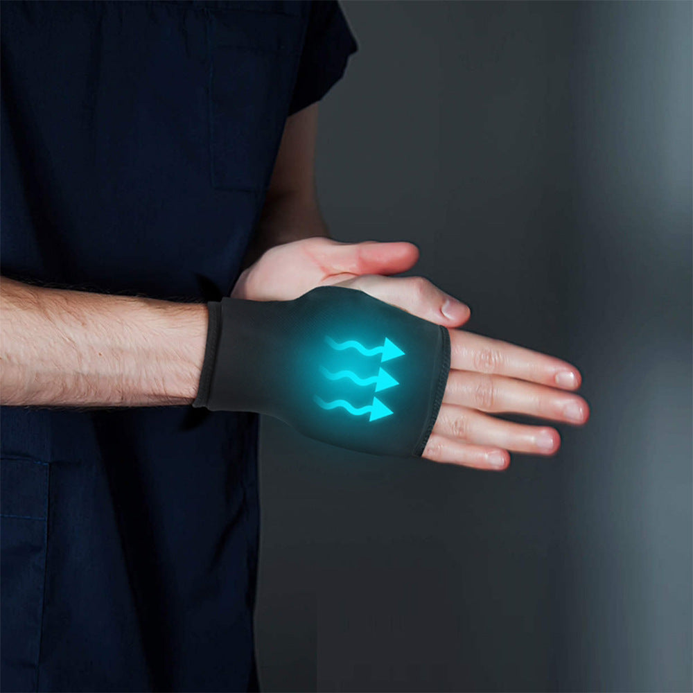 Person wearing a glove with a glowing green symbol on a dark background