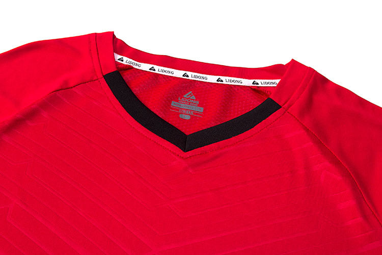 Red sports jersey with black trim on a white background