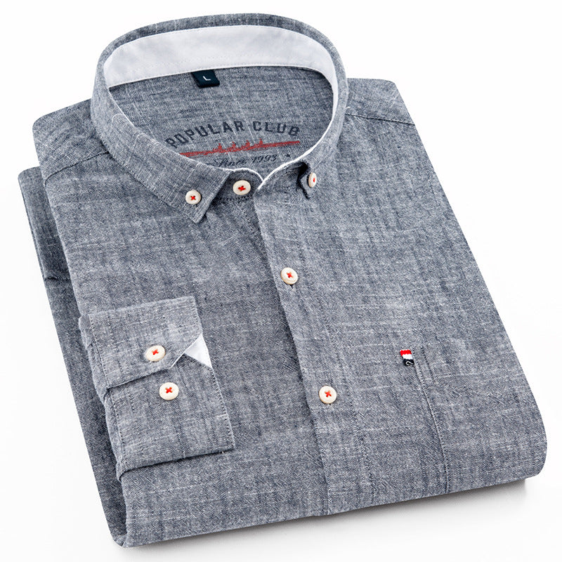Folded gray shirt with brand label on a white background