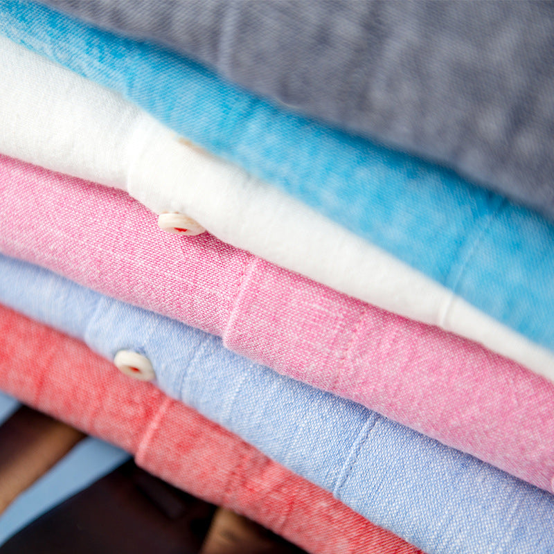 Stack of colorful fabric swatches including blue, pink, red, and gray.