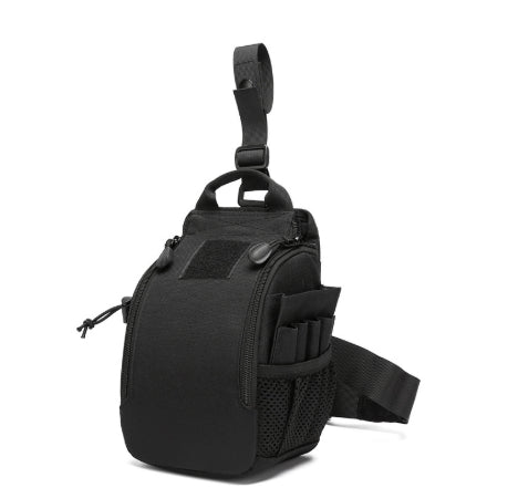 A black tactical sling bag with a top carry loop, front zippered compartment, mesh side pocket, and adjustable shoulder strap, shown on a plain white background.