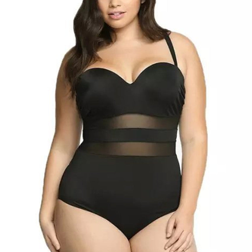 Black swimsuit with sheer mesh panels worn by a model on a white background