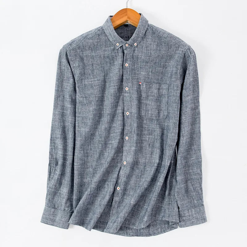 Blue checkered shirt on a wooden hanger against a white background