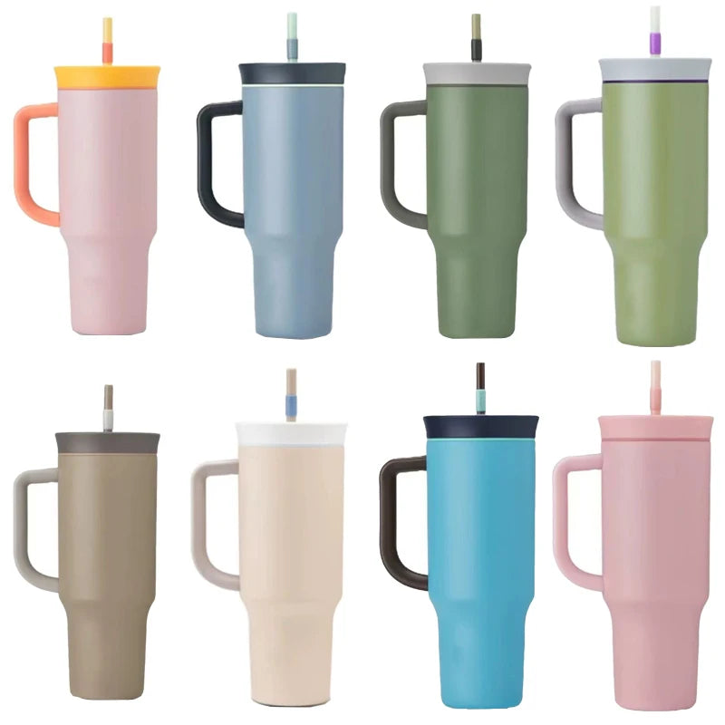 Eight handled travel tumblers in assorted colors, each with a lid and straw, arranged in two rows.