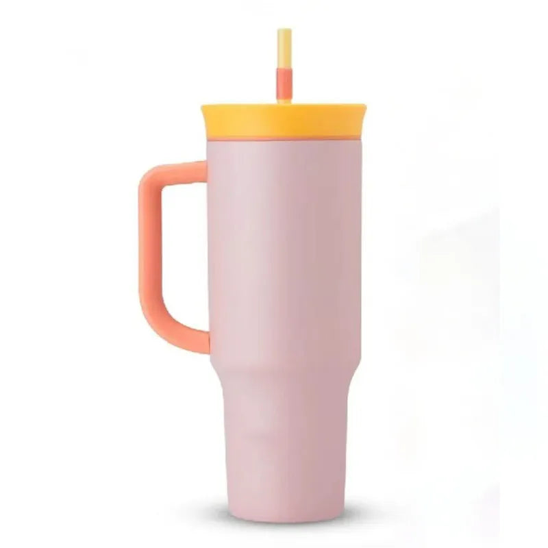 Pale pink travel tumbler with coral handle, yellow lid and two-tone straw on a white background.