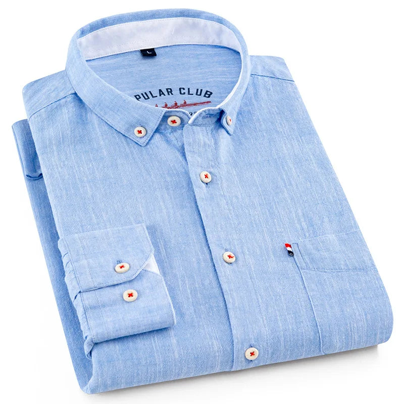 Folded light blue shirt with brand label on a white background