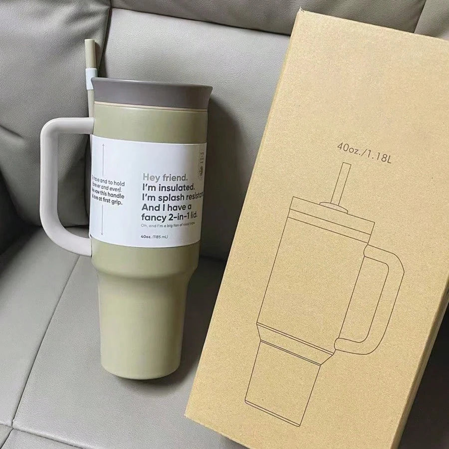Olive-green 40 oz travel tumbler with gray handle, lid and straw beside a cardboard product box.
