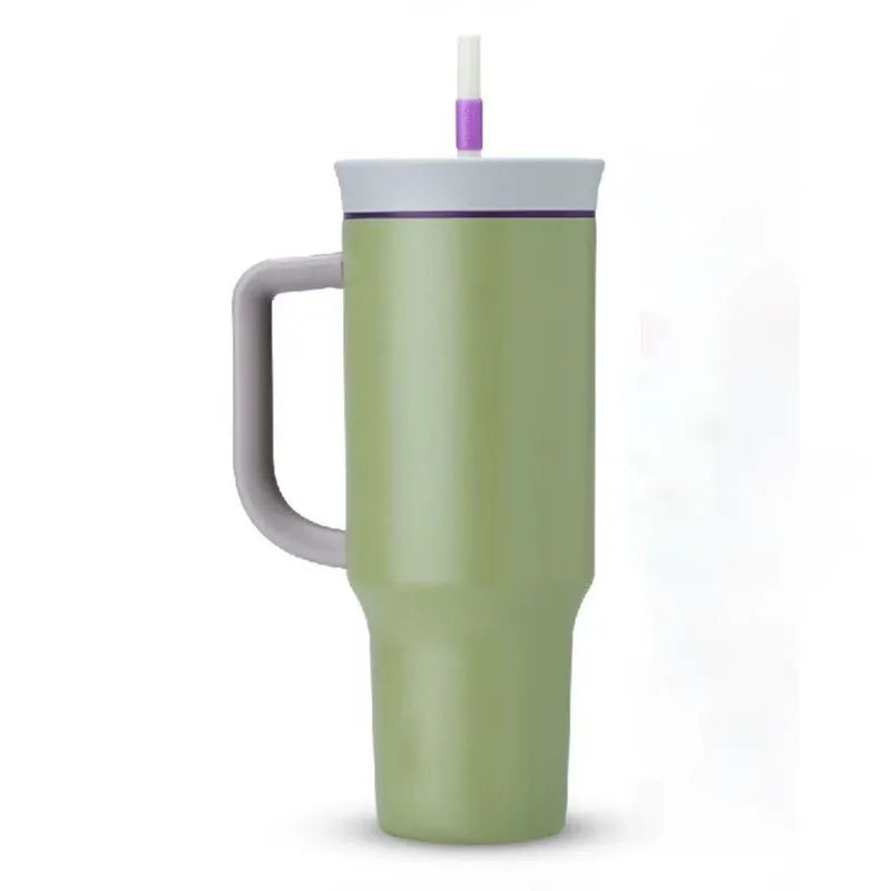 Light green travel tumbler with gray handle and lid, purple accent and straw on a white background.