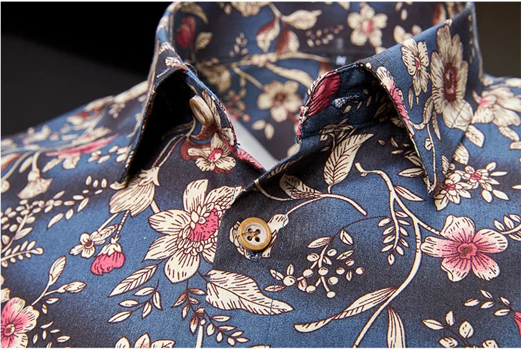 Close-up of a floral-patterned shirt with rolled-up sleeves.