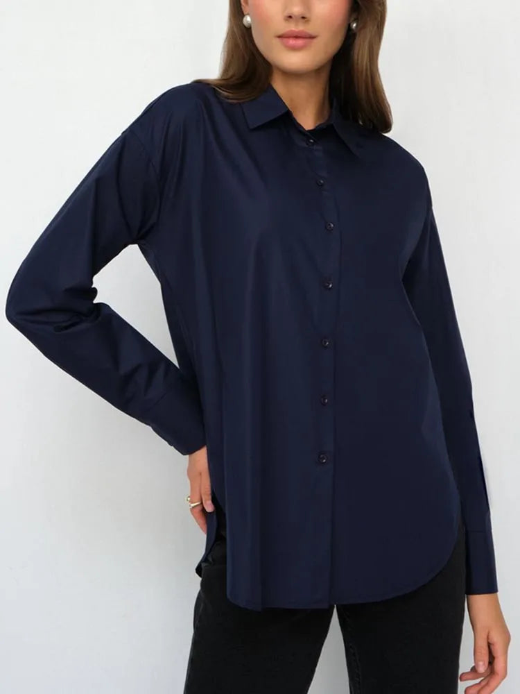 Woman wearing a navy blue shirt against a white background