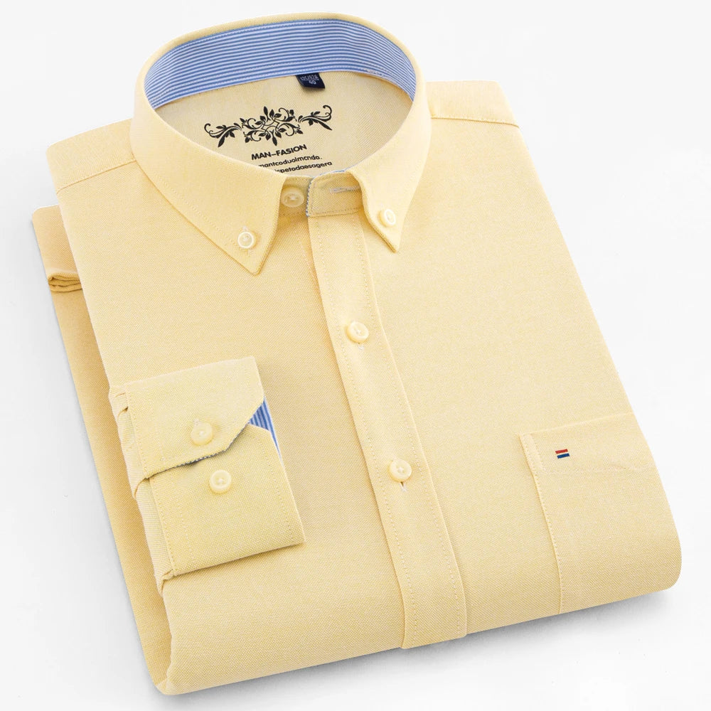 Folded yellow shirt with a blue collar on a light gray background