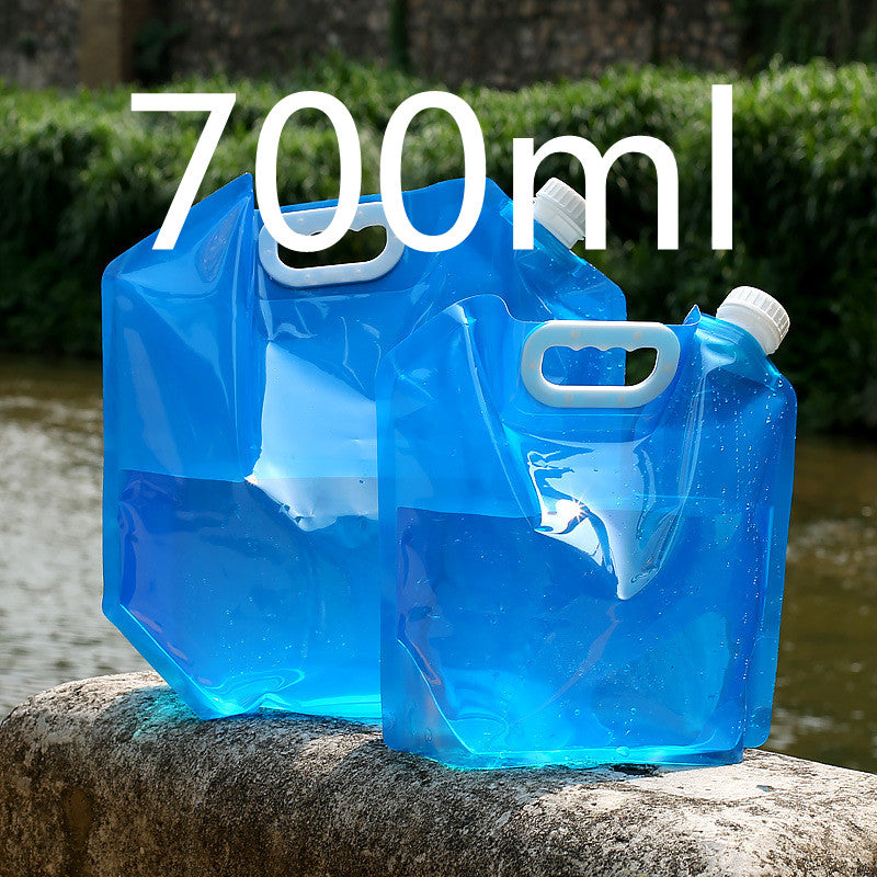 Blue water container with handles on a stone ledge outdoors, labeled '700ml'.