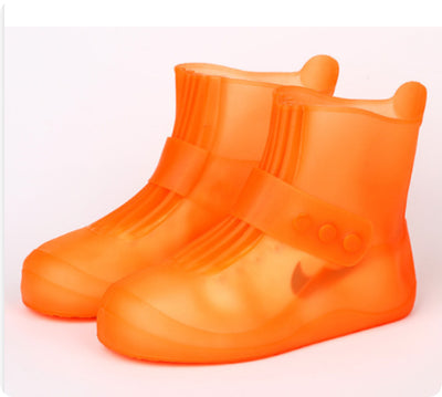 Orange rain boots on a white background